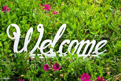 Metal White Welcome Sign On Flower Background Stock Photo