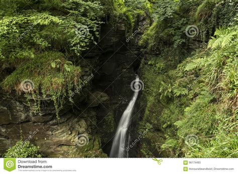 Beautiful Flowing Waterfall With Magical Fairytale Feel In Lush Stock