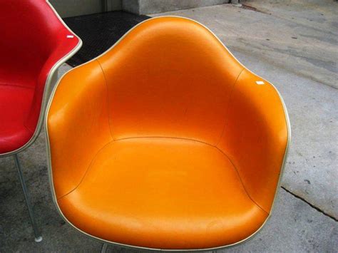 These chairs boast a plastic seat and wooden legs with metal supports. Eames Shell Chair Knock Off - Madison Art Center Design