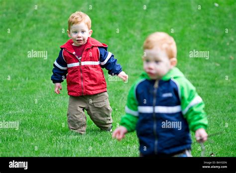 Twin Boys Playing Outside On Grass Stock Photo Alamy