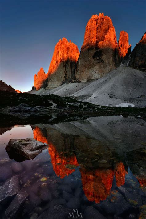 The Mountains Are Reflected In The Still Water At Sunset With Red