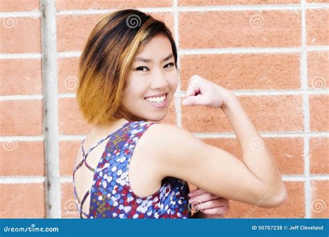 Smiling Skinny Asian American Woman Undressing Outdoors Royalty Free