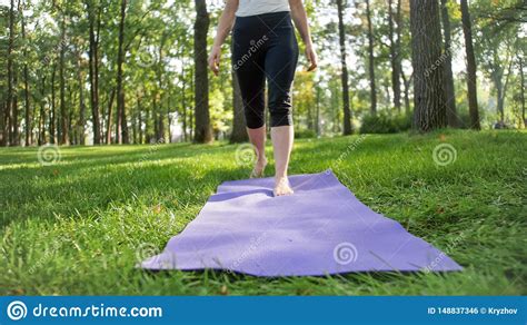 Closeup Photo Of Female Feet Walking On The Fitness Mat Lying On Grass