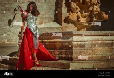 Medieval Beautiful Brunette Woman Wearing Gold And Copper Corset In Goddess And Warrior Poses