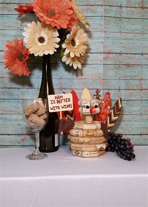 A Vase With Flowers And Some Wine Corks