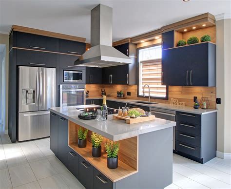 A Modern Kitchen With Stainless Steel Appliances And Wood Accents On