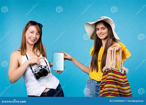 Young Attractive Tourists Are Holding A Tablet With A Blank White