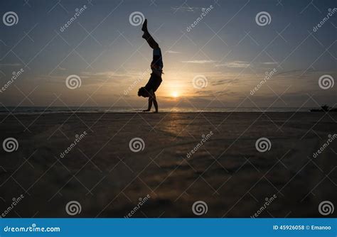 Silhouetted Man Doing Handstand In Sunset Stock Photo Image Of