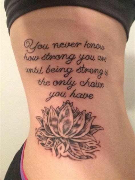 A Womans Back With A Tattoo Saying You Never Know How Strong You Are