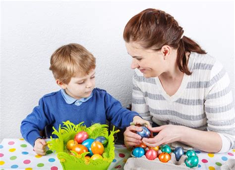Little Toddler Boy And His Mother Being Happy About Selfmade Easter Egg
