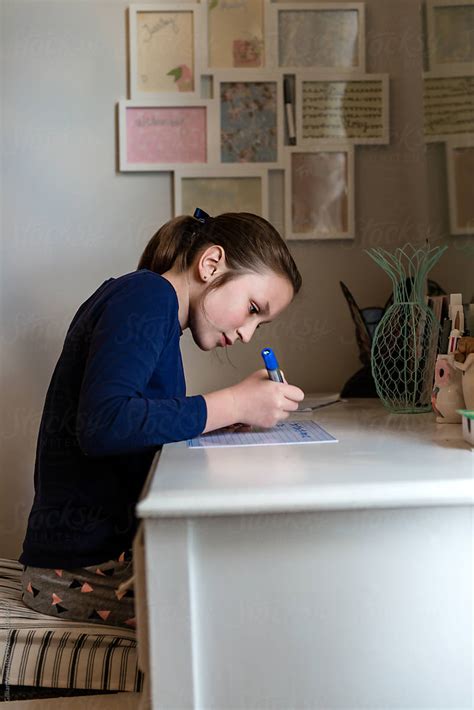 Teenager Doing Homework In Her Bedroom By Stocksy Contributor