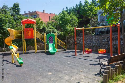 Colorful And Empty Playground In The Park Among The Houses Children