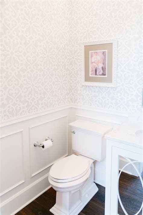 Powder Room Bathroom With Beautiful Wallpaper And Wainscoting Designed