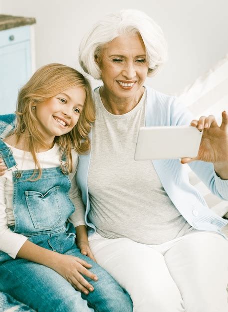 Premium Photo Grandmother Making Selfie With Granddaughter
