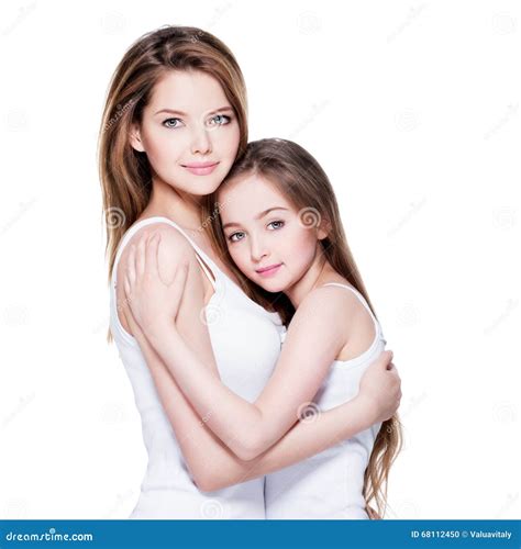 Beautiful Young Mother With A Small Daughter 8 Years Embrace Each Other