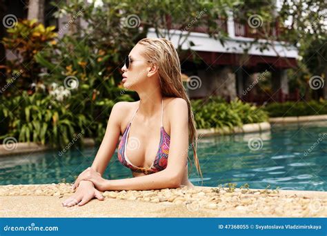 woman with blond hair in bikini relaxing in swimming pool stock image image of bijou