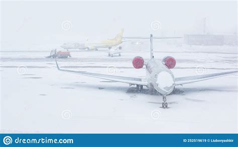 Snow Covered Commercial Plane At The Airport Close Up Of The Plane