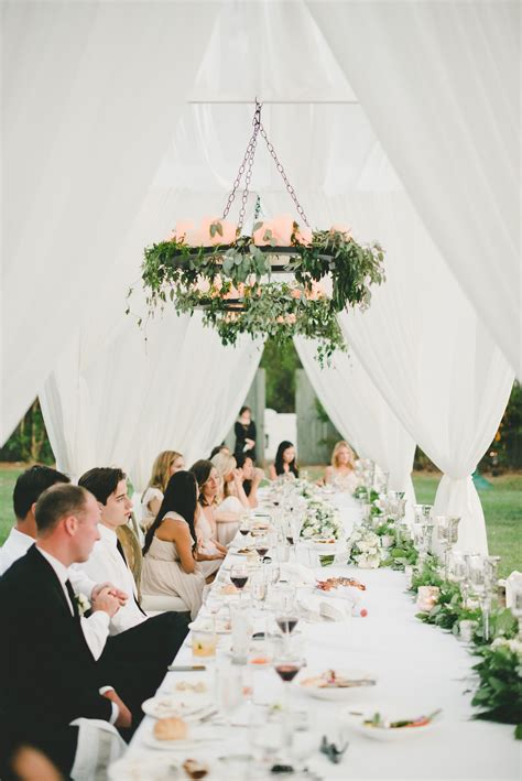 Draping Sheer Canopies And Greenery Wrapped Candelabras Gave The Long