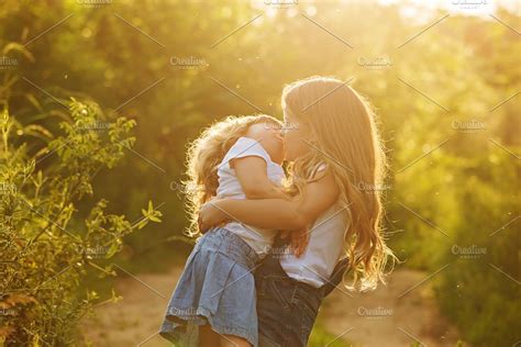 Two Cute Little Sisters Kiss High Quality People Images ~ Creative Market