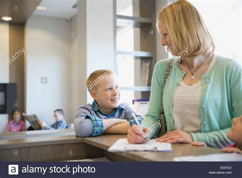 Woman Filling Out Paperwork At Dentists Office Stock Photo Alamy