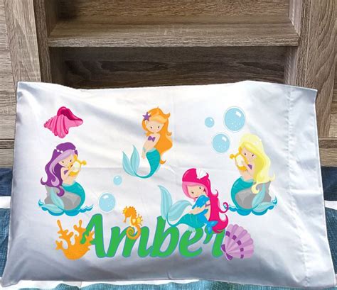 The Personalized Pillow Case Has Mermaids On It