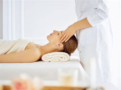 Beautiful Woman Enjoying Facial Massage With Closed Eyes Spa Treatment Concept In Medicine