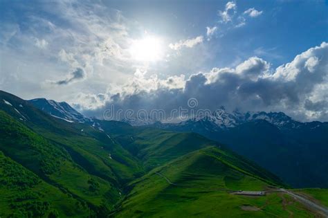 Landscape Mountain View Peaks In Snow And Green Hills Deep Blue Sky
