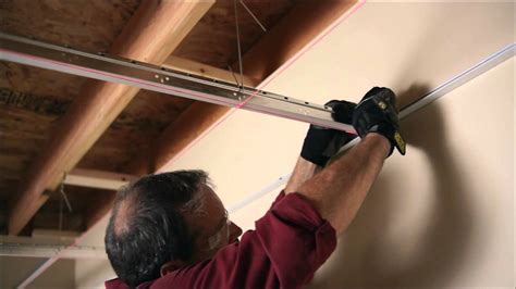 Remove all of the ceiling tiles from the frame of the drop ceiling and determine where on the ceiling the track lighting will be installed. Installing Your USG Ceiling Grid and Tile - YouTube