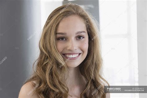Portrait Of Blond Smiling Teenage Girl Smiling Front View Close Up