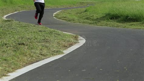 Road Runner Male Legs Feet Running On Road Of Urban City With Sunset