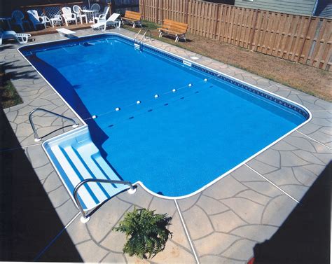 This Rectangle Pool Features A Stamped Concrete Deck And Legacy