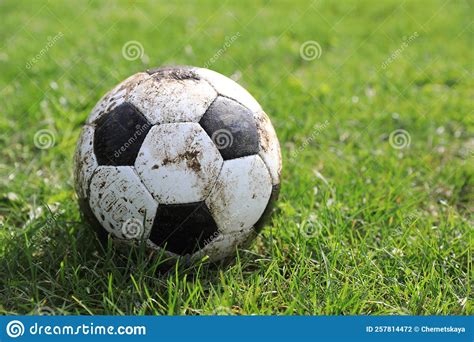 Dirty Soccer Ball On Green Grass Outdoors Space For Text Stock Photo
