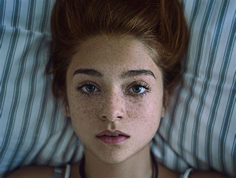 Beautiful Portrait Of A Girl With Freckles Lying Down On A Pillow
