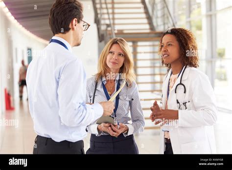 Three Young Male And Female Doctors In Consultation Stock Photo Alamy