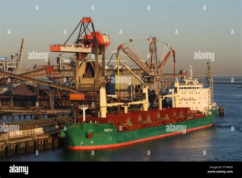 North Sea Tufty Bulk Carrier In Rotterdam Harbour At Sunrise With