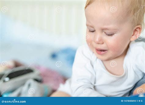 Cute Caucasian Blond Toddler Boy Portrait Crying At Home During