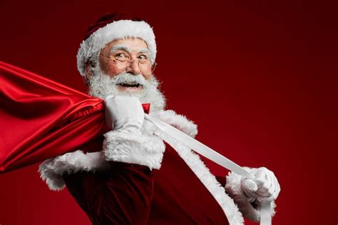 Premium Photo Santa Claus Holding Sack With Presents
