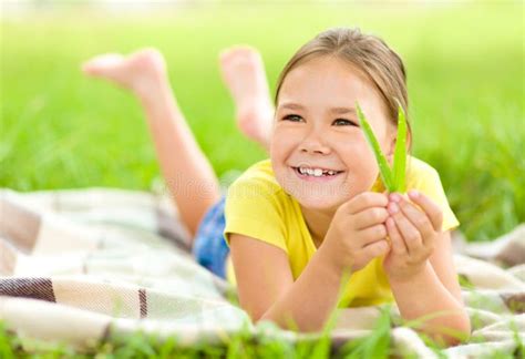 Portrait Of A Little Girl Laying On Green Grass Stock Image Image Of