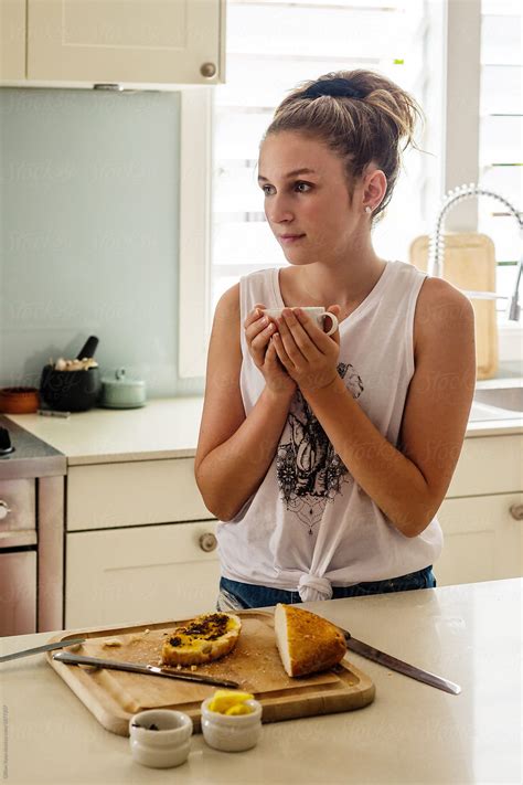 Teen In Kitchen With A Cup Of Tea Del Colaborador De Stocksy Gillian