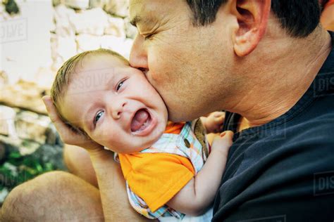 Caucasian Father Kissing Baby Boy Outdoors Stock Photo Dissolve