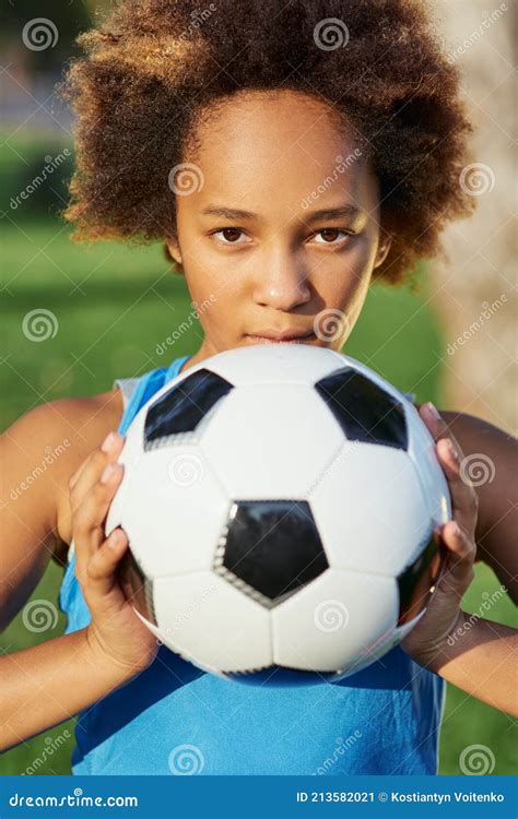 Cute Afro American Girl With Soccer Ball Standing In The Street Stock