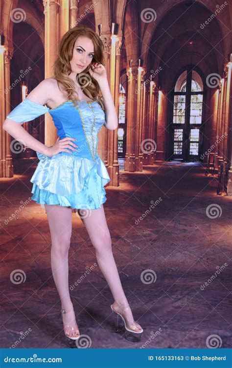 Beautiful Tall Slim Busty Redhead Model Dressed As Cinderella At The Ball Stock Image