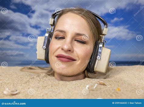 Woman Buried In Sand On Beach With Headphones Stock Photo Image Of