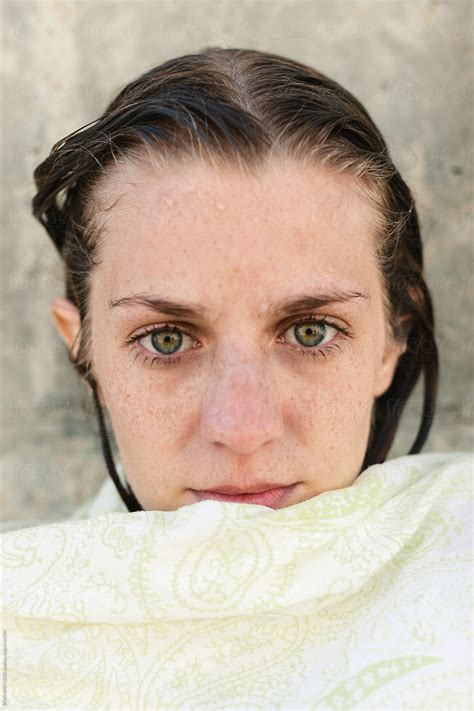 Portrait Of A Young Woman With Wet Hair Covered With A Towel Outdoors By Stocksy Contributor