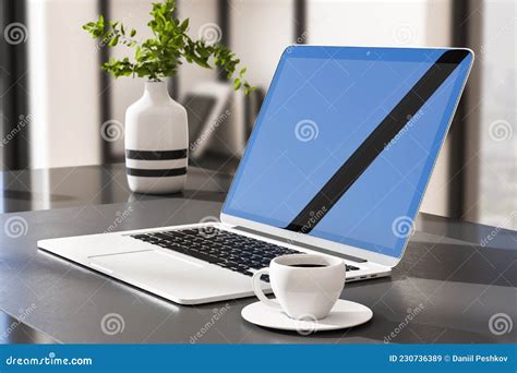 Close Up Of Laptop Computer With Reflections On Screen And Coffee Cup