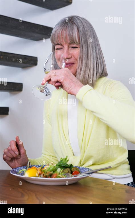 Happy Woman Drinking Wine At Dining Table Stock Photo Alamy