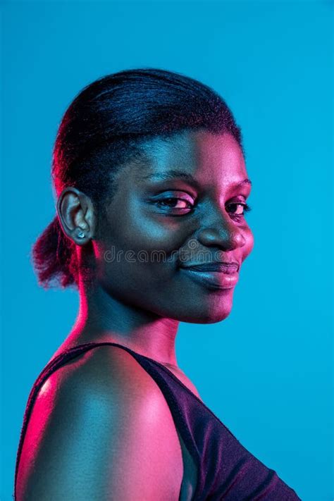 Close Up Of Young Beautiful Dark Skinned Woman Posing Isolated On Blue