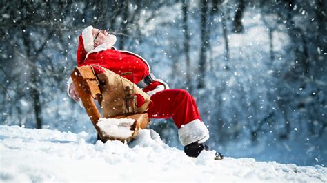 Santa Claus Is Sitting On Bench During Snow Falling Hd Christmas