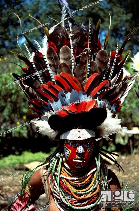 A Woman In Ceremonial Dress Wearing A Feathered Headdress Papua New