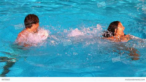 Couple Splashing And Having Fun In Swimming Pool Stock Video Footage 4470065